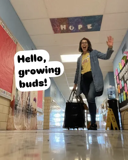 Jennifer walks down a school hallway waving, words "Hello growing buds!"